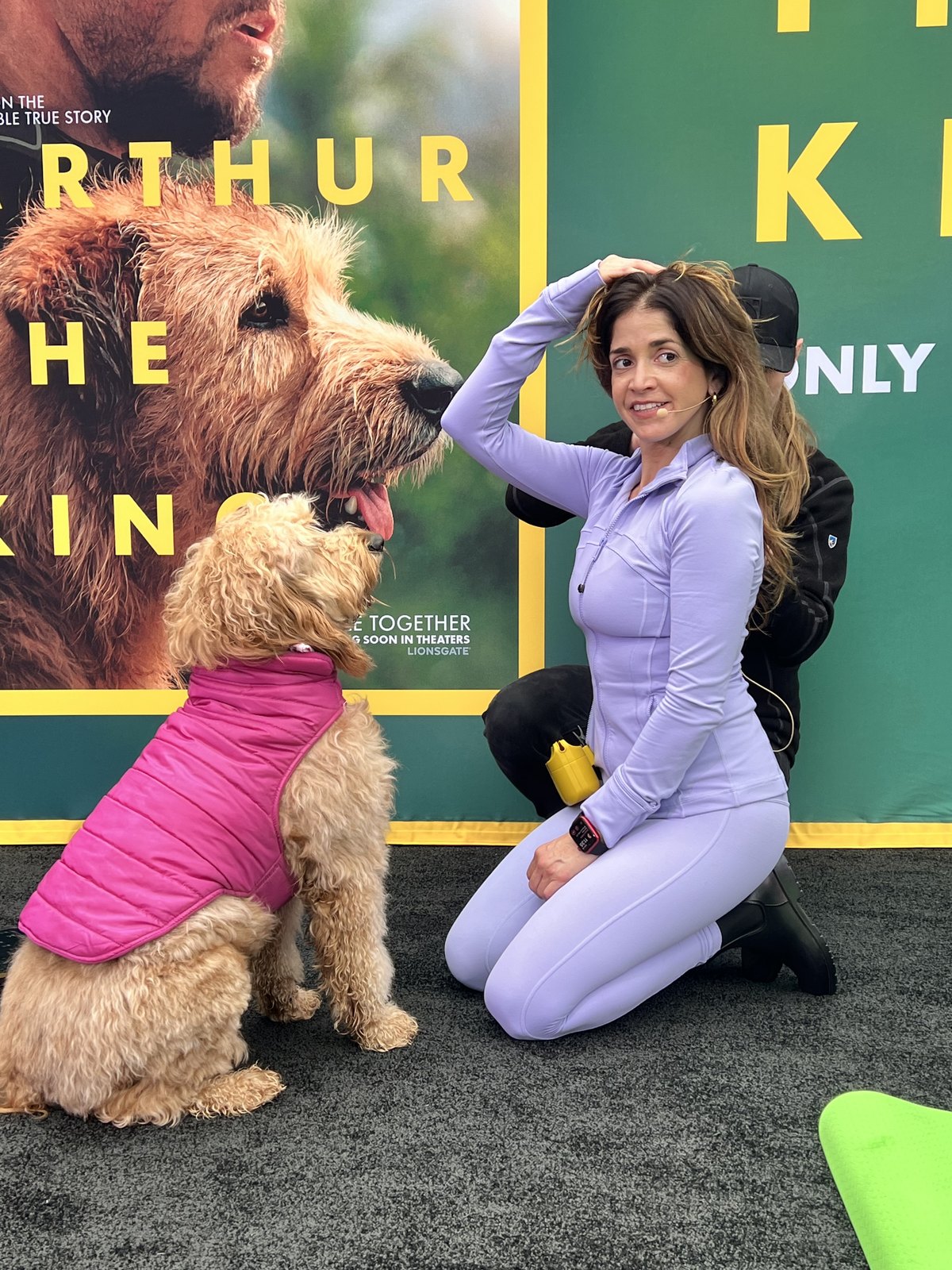 Peach the Goldendoodle and handler Lauren Pena at the Arthur the King step and repeat