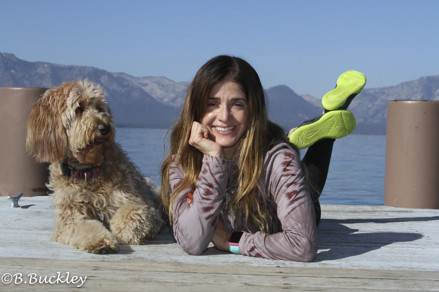 Lauren Pena and Peach the Goldendoodle on a Lake Tahoe pier at dog camp, photo by Barb Buckley